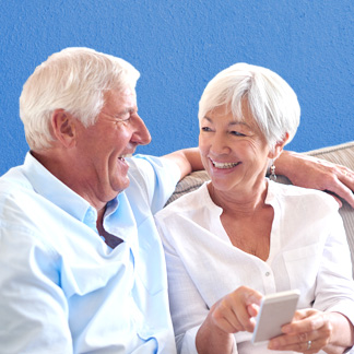 Senior couple using cellphone together