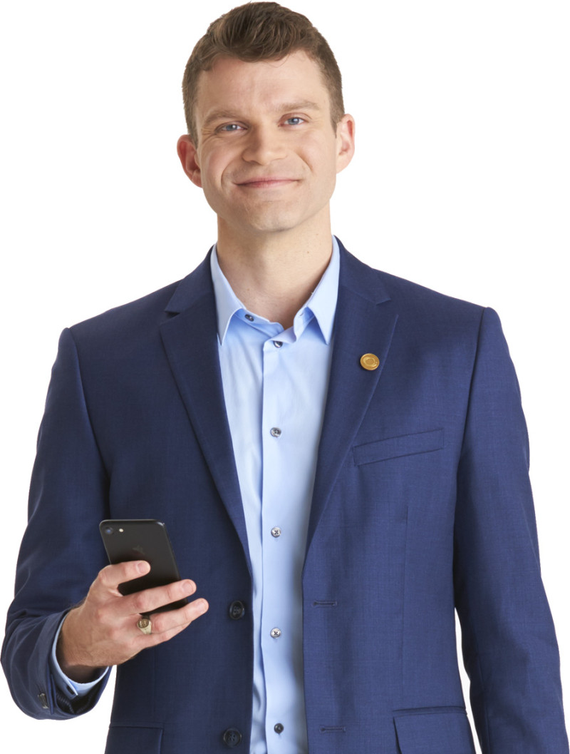 businessman holding mobile device smiling at camera