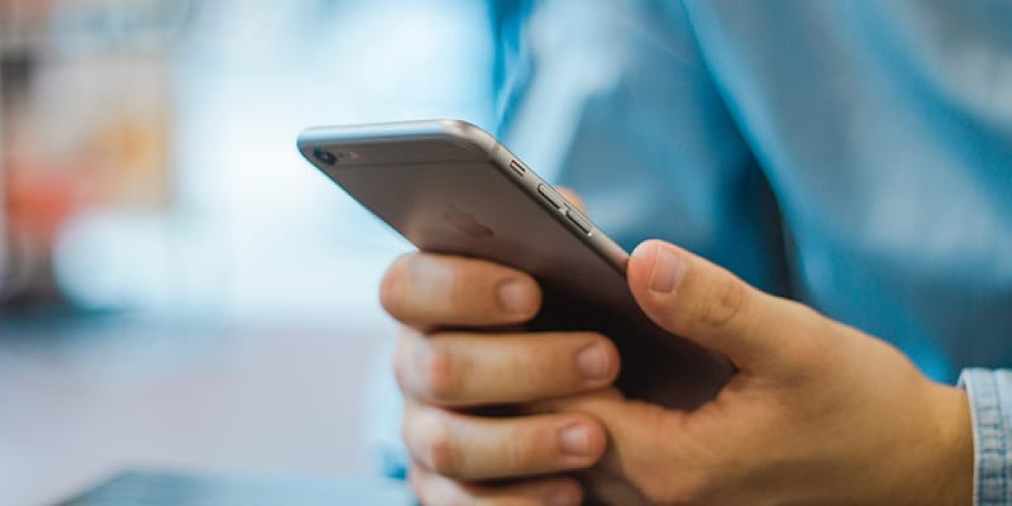 Close up of person holding an iPhone